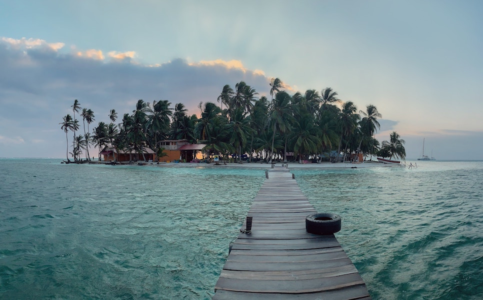 the view of a tropical private island viewed from its long pier