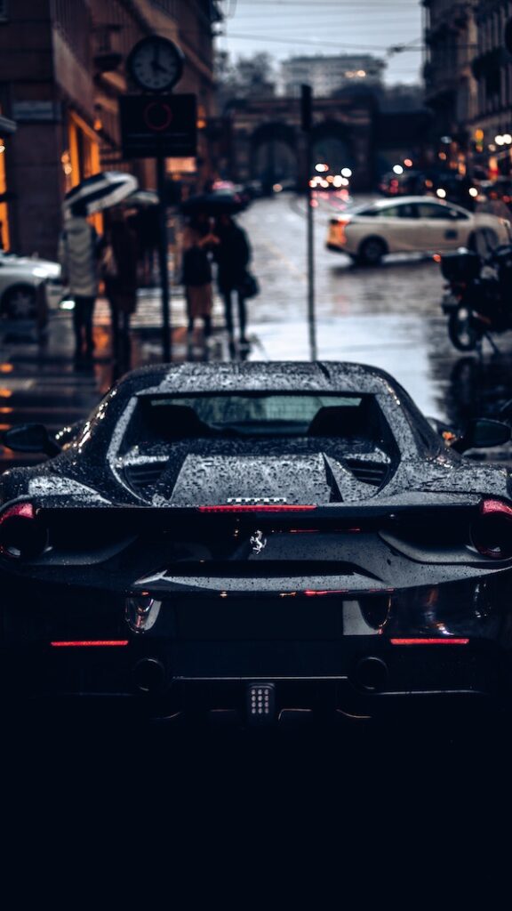 a Ultra-Luxury Car in the street on a rainy day