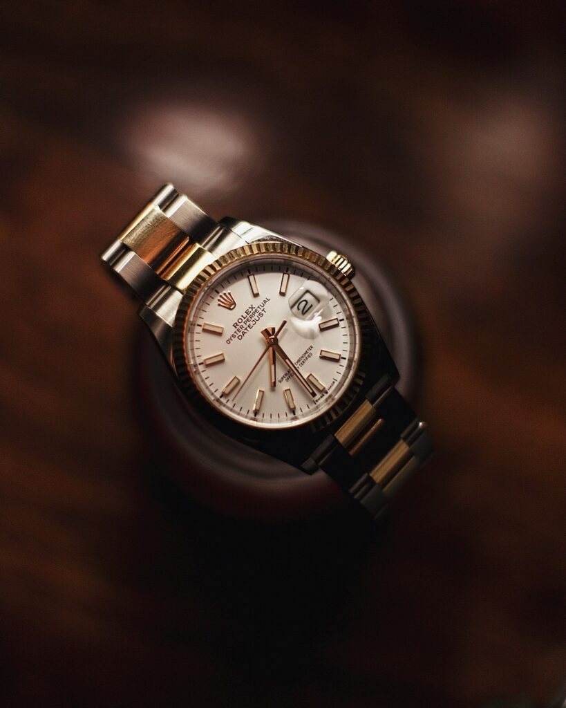 closeup shot of a luxury watch in display on a wooden piece